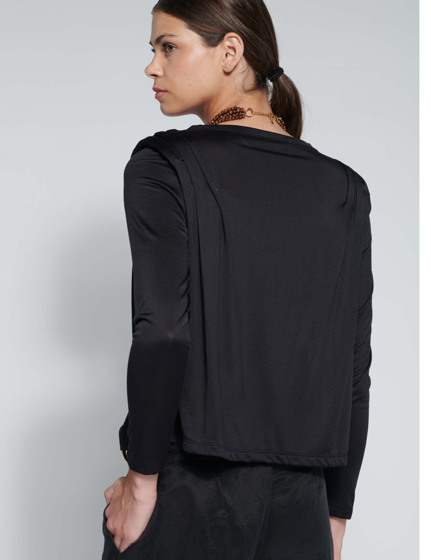 Polera Bloom Black de O-2026-502, blusa negra de estilo casual con cuello redondo y manga larga, vista frontal sobre fondo blanco.