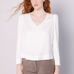 Blusa Jeanie de la marca EI-2025-608 en color crudo, con diseño de manga larga y cuello redondo, vista frontal.
