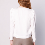 Blusa Jeanie de la marca EI-2025-608 en color crudo, vista frontal, con detalles de tela suave y diseño elegante.