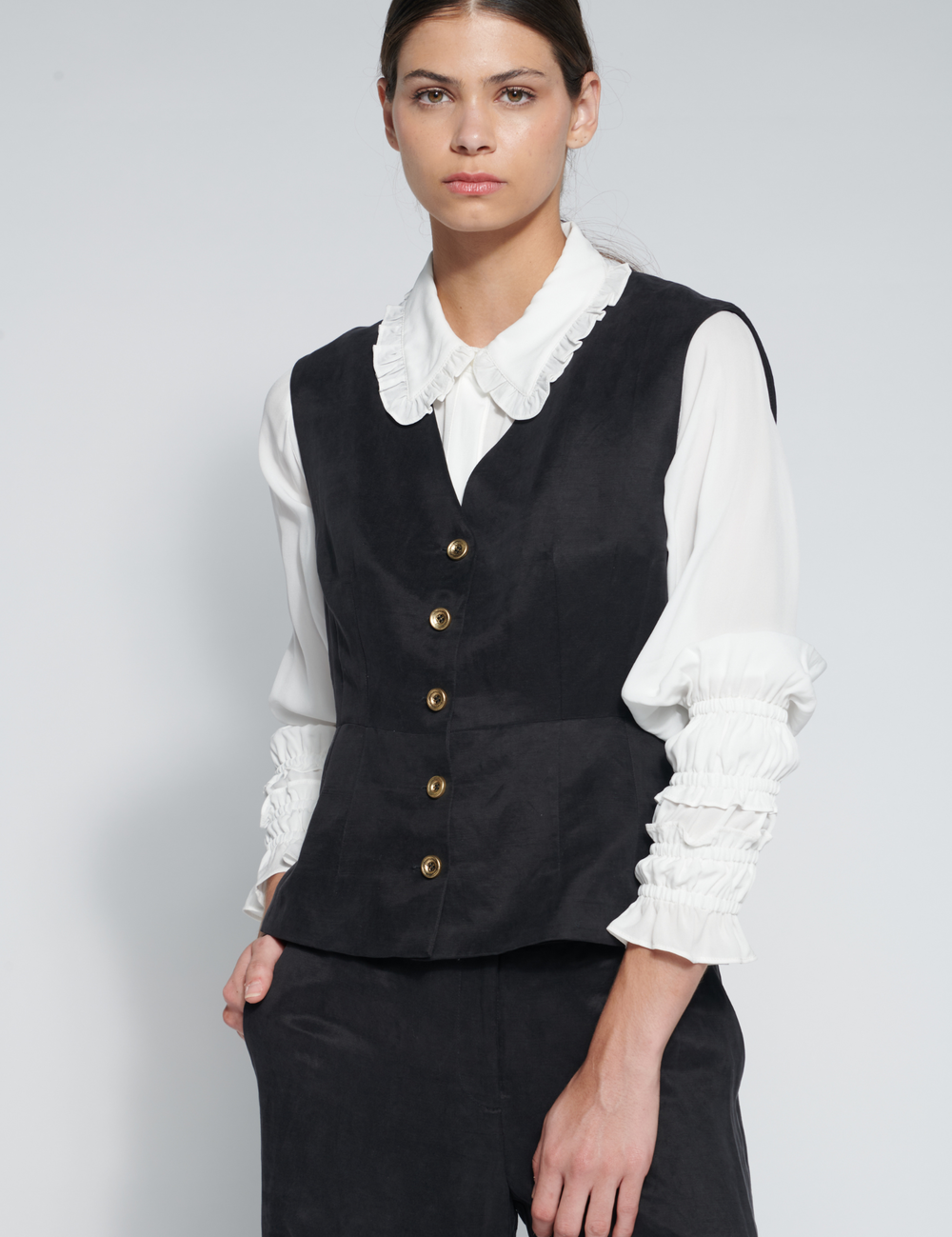Chaleco Zini negro de tejidos, con diseño elegante y ajustado, visible en la imagen.
