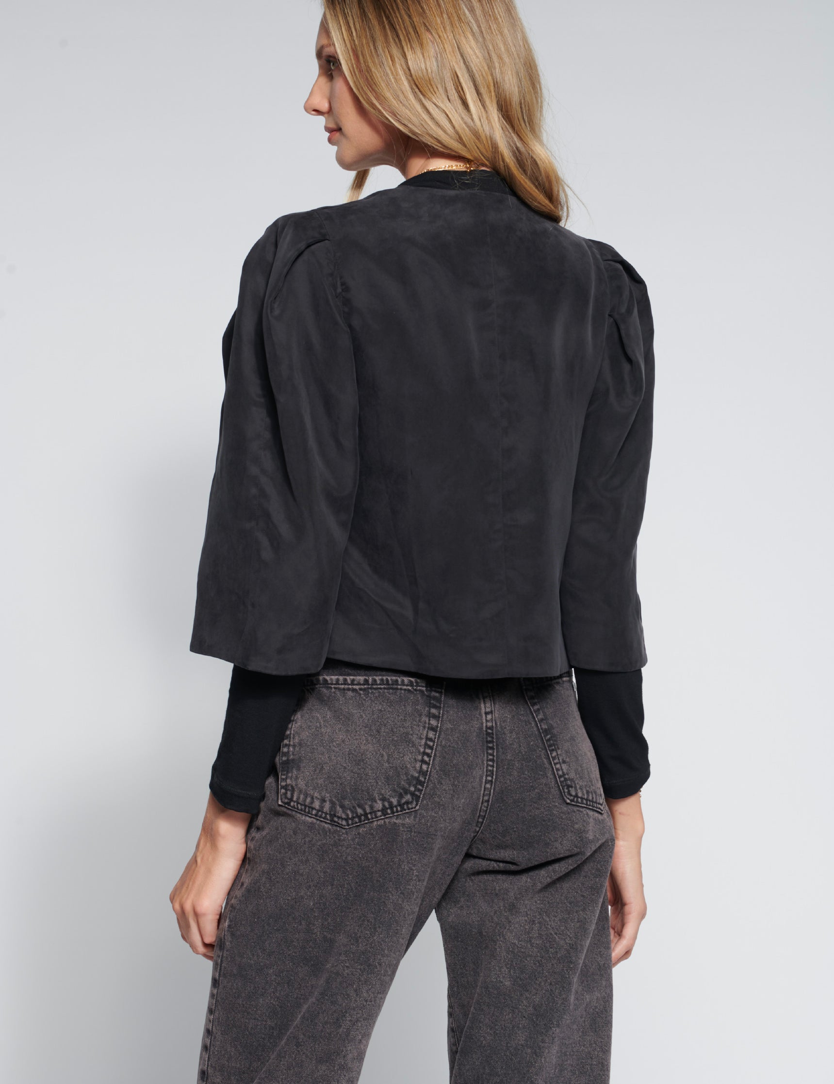 Chaqueta Toral Black de la marca FI-2026-902, abrigo negro con diseño moderno y cierre frontal, vista en posición lateral.
