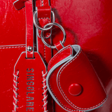 Cartera shopper roja AI-2025-100 con asas, diseñada para accesorios y uso diario, con acabado elegante y resistente.