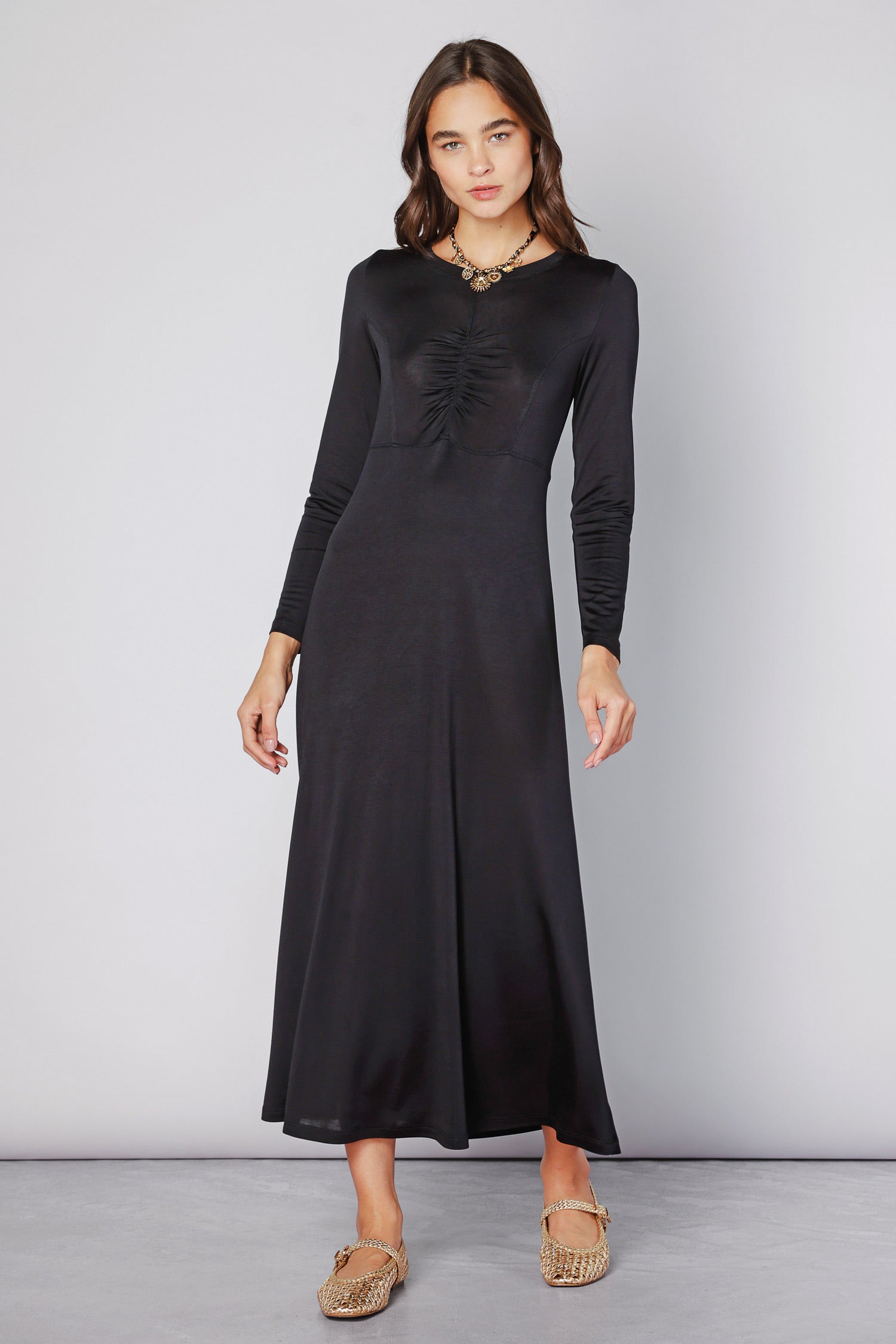 Vestido negro Lyla de la marca O-2025-701, vestido elegante con diseño simple y moderno, montado en maniquí.